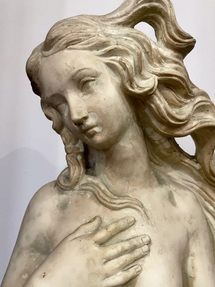 Weathered classical sculpture with a gentle expression